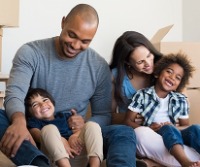 Family in house surrounded by moving boxes